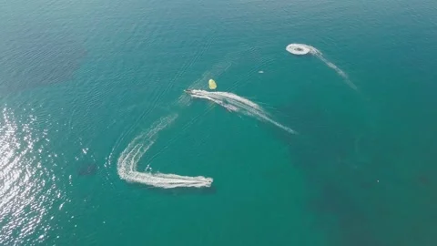 Parasailing is active type of recreation, person on parachute soars through air. 스톡 동영상 165043888