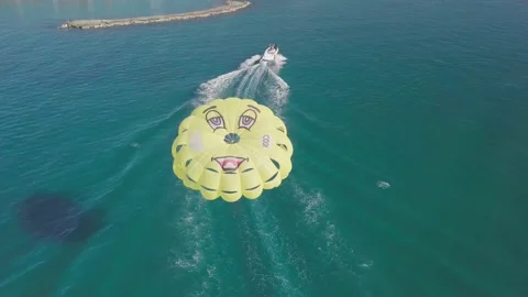 Parasailing is active type of recreation, person on parachute soars through air. Stock Footage 165157472