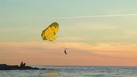 Parasailing is active type of recreation, person on parachute soars through air. Stock Footage 165601592