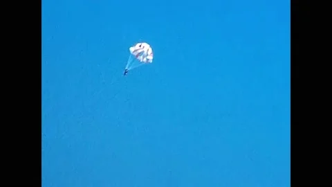 Parasailing is active type of recreation, person is fixed with long cable to  Stock Footage 171567737