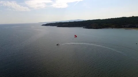 Parasailing in Black Sea in front of sandy beaches in Bulgaria Sozopol with wind Stock Footage 78771503