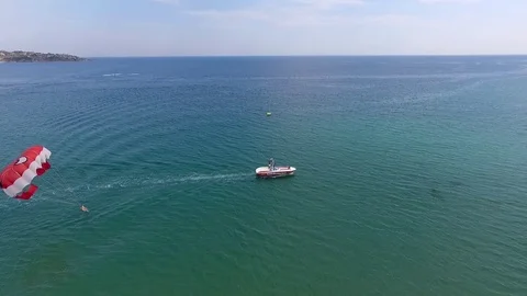 Parasailing in Black Sea in front of sandy beaches in Bulgaria Sozopol with wind Stock Footage 78772893