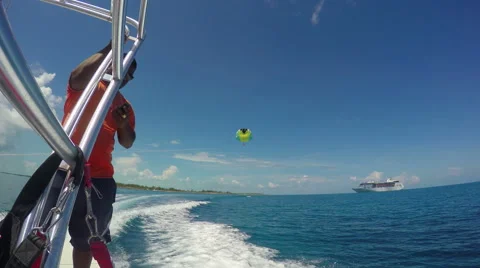 Parasailing with cruise ship in background Stock Footage 64874770