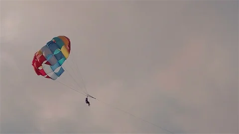 Parasailing in evening. Bright parachute on a background of a sky. Video stock 105000199