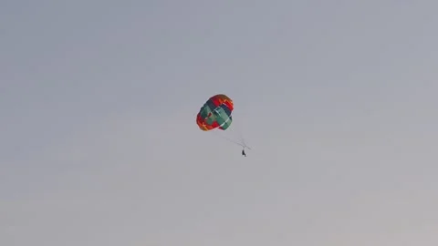 Parasailing in evening. Bright parachute… | Stock Video | Pond5