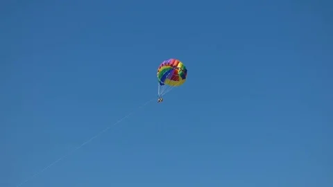 Parasailing high in the blue sky 動画素材 77443715