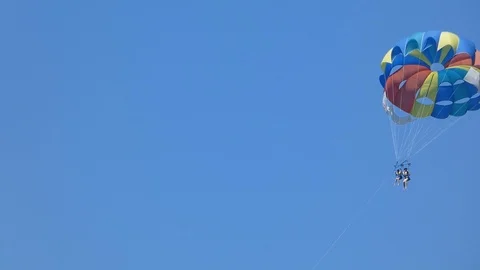 Parasailing high in the blue sky Stock Footage 94099438