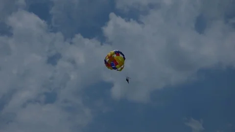 Parasailing high in the sky, with clouds at the background Stock-Footage 77443800