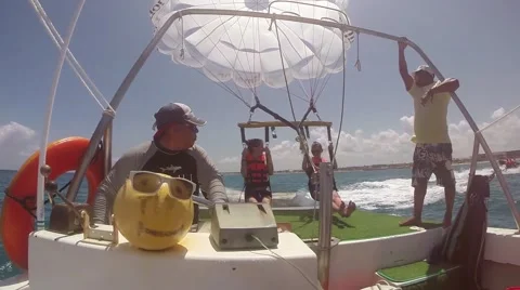 Parasailing launch off the back of a boat Stock Footage 45625150