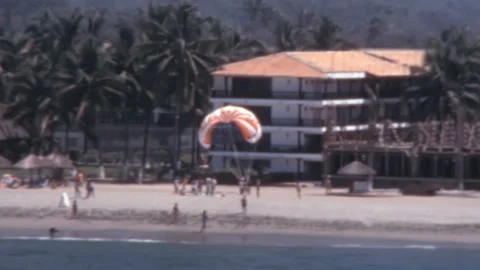 Parasailing Over Beach Resort With Coconut Palms Mexico 1980s Stock Footage 345421054