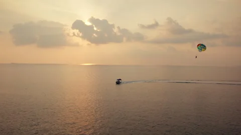 Parasailing over the tranquil ocean at sunset Stock-Footage 320062230
