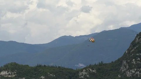 Parasailing Parachute Boating over the beach with alps mountains on the backg Stock Footage 85483622