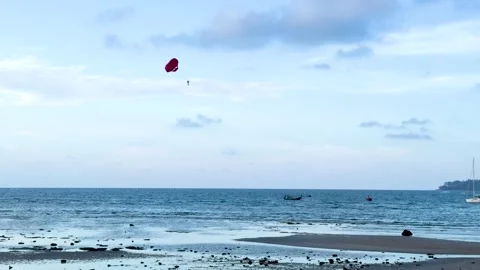 Parasailing with a Red Parachute Over the Ocean in Phuket Thailand Stock Footage 330383718