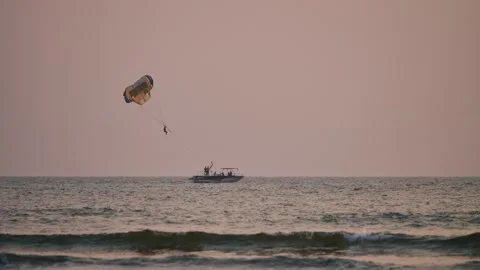 Parasailing on the sea at sunset Stock Footage 265878400