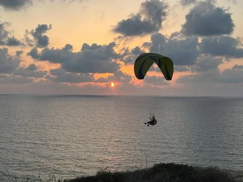 Parasailing at sunset  写真素材