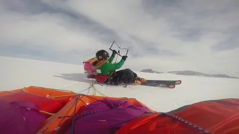 Parasailing while lying on the snow Stock Footage 79978977