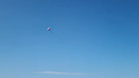 Parasailor is returning to the ground after a thrilling ride Stock Footage 286008372