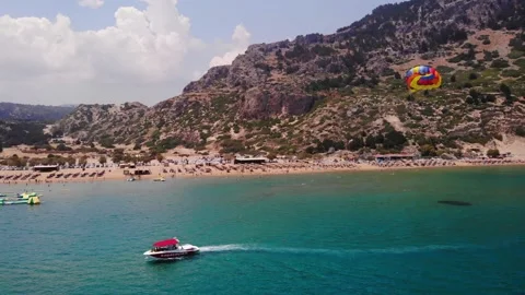 Paraskiing - Vacationist Ride On Canopy Connected To Speedboat Crusing In 動画素材 202005930