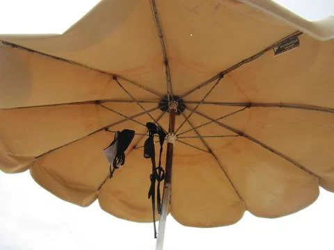 Parasol with bikini Stock Photos