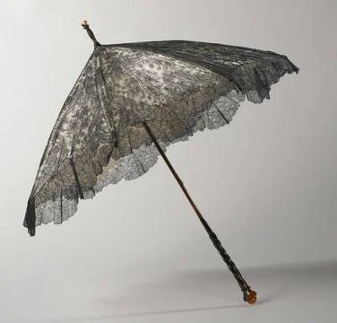 . Parasol with a deck of black silk chantilly climbing side on a backgroun... Stock Photos