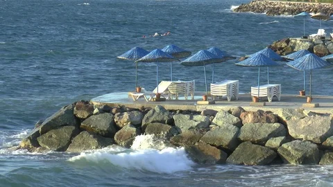 Parasols And Breaking Waves Stock Footage 121263621