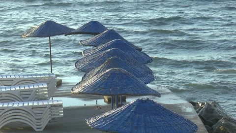 Parasols And Breaking Waves Stock Footage 121325410