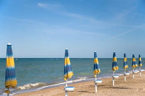 Parasols at the beach Stock Photos