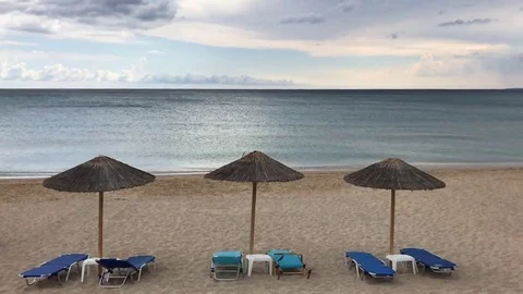 Parasols Cloudy summer sea beach ,slow motion  Stock Footage 80361972