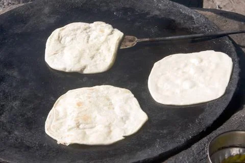 Paratha baking on round iron surface ; West Bengal ; India Copyright: xDut... Фото