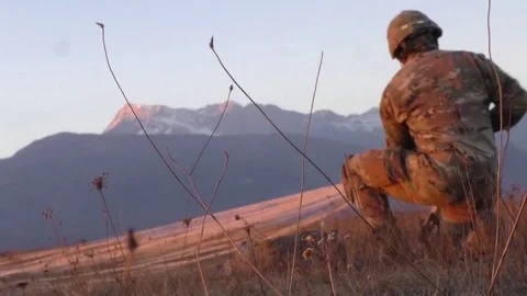 Paratrooper pulling parachute after landing during airborne operation Stockbeeldmateriaal 84884001