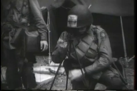 Paratrooper sets up tripod and paratroopers with full packs line up - 1944-1945 Stock Footage 112173653