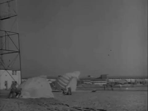 Paratrooper trainees take their first jump from a plane in 1951, Lawson Army Stock Footage