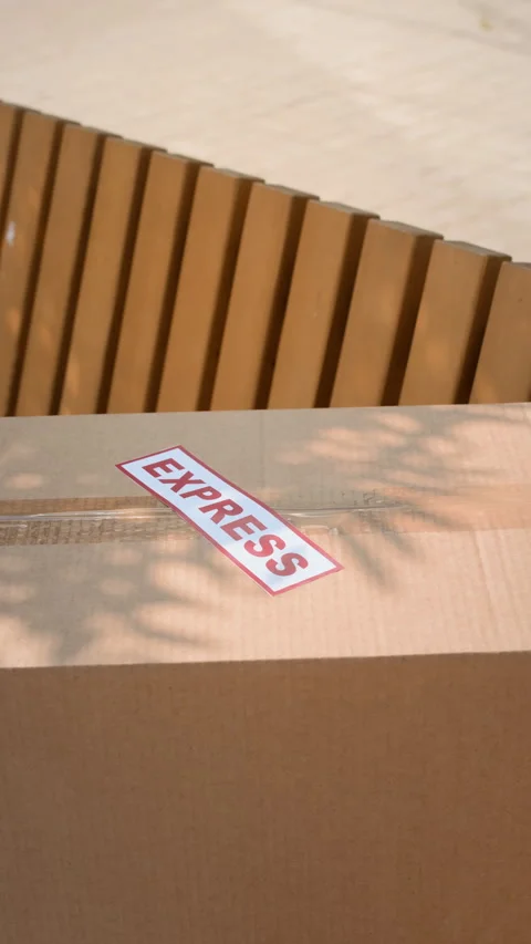 Parcel in Box with Express Delivery Label on Wooden Bench Stock Footage 280379053