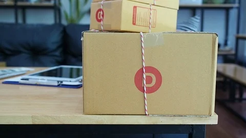 Parcel boxes on desk table in modern interior office. Stock Footage 115080882