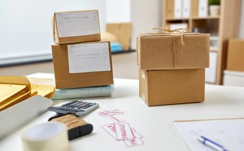 Parcel boxes on table at post office Stock Photos