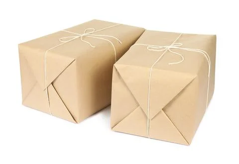 Parcel boxes wrapped in paper isolated on white Stock Photos