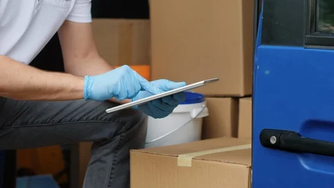 Parcel delivery - close-up of hands and digital tablet Stock Footage 129697169