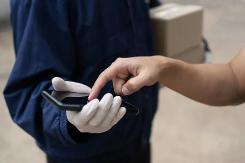 Parcel delivery concept the client pointing to confirm the ordered items at b Stock Photos