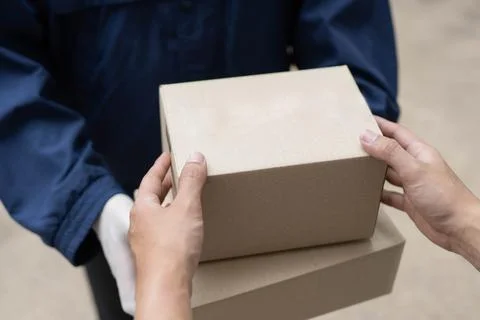 Parcel delivery concept the postman in white rubber gloves and light weight d Stock Photos