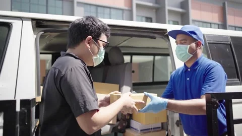 Parcel delivery staff pick up the package from the trunk of the car and deliver  Stock Footage 149805033