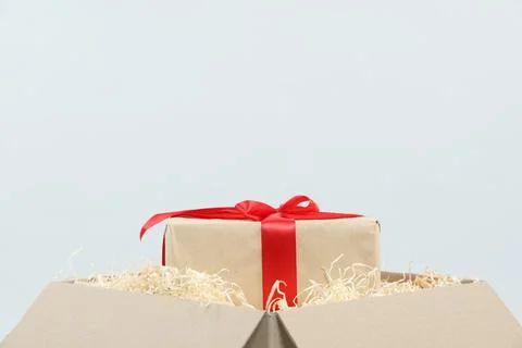 Parcel with gift box on light background, closeup Stock Photos