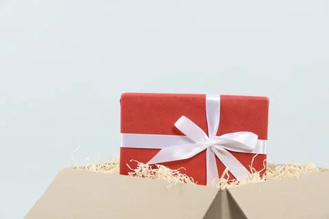Parcel with gift box on light background, closeup 写真素材