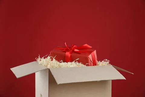 Parcel with gift box on red background 写真素材