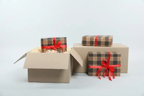 Parcel with gift boxes on light background Foto stock