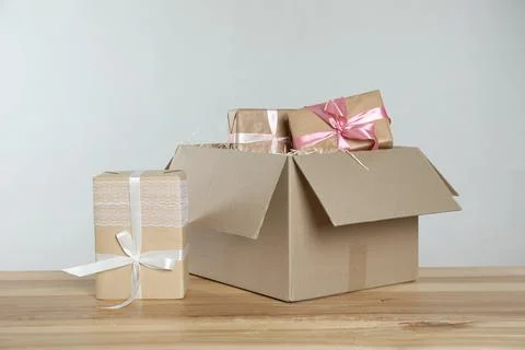 Parcel with gift boxes on wooden table against light background 스톡 사진