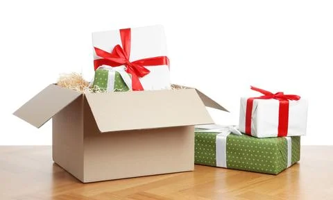 Parcel with gift boxes on wooden table against white background 스톡 사진