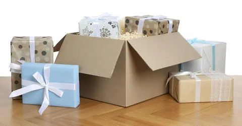 Parcel with gift boxes on wooden table against white background Foto stock