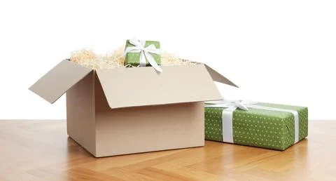 Parcel with gift boxes on wooden table against white background Foto stock