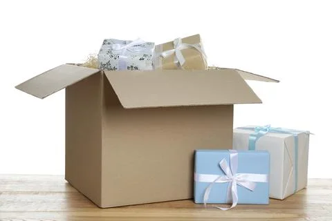 Parcel with gift boxes on wooden table against white background 스톡 사진