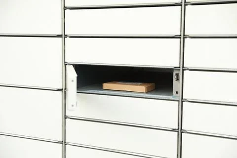 Parcel in locker of automated postal box Stock Photos